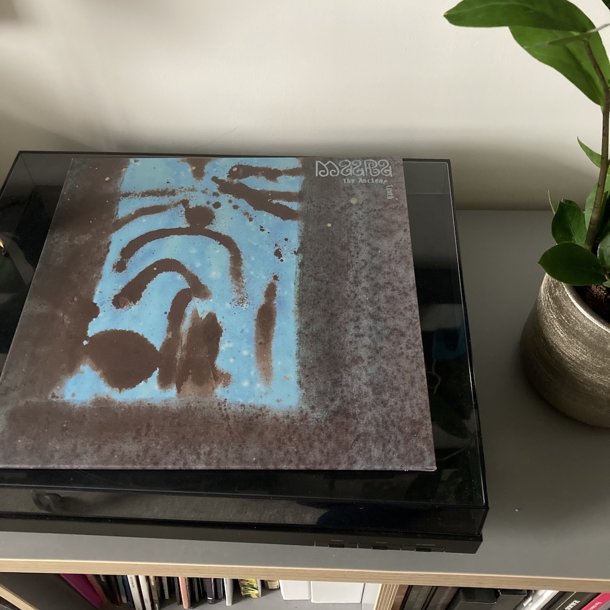 A copy of the album The Ancient Truth by Maara on top of my turntable watched over by pot plants.